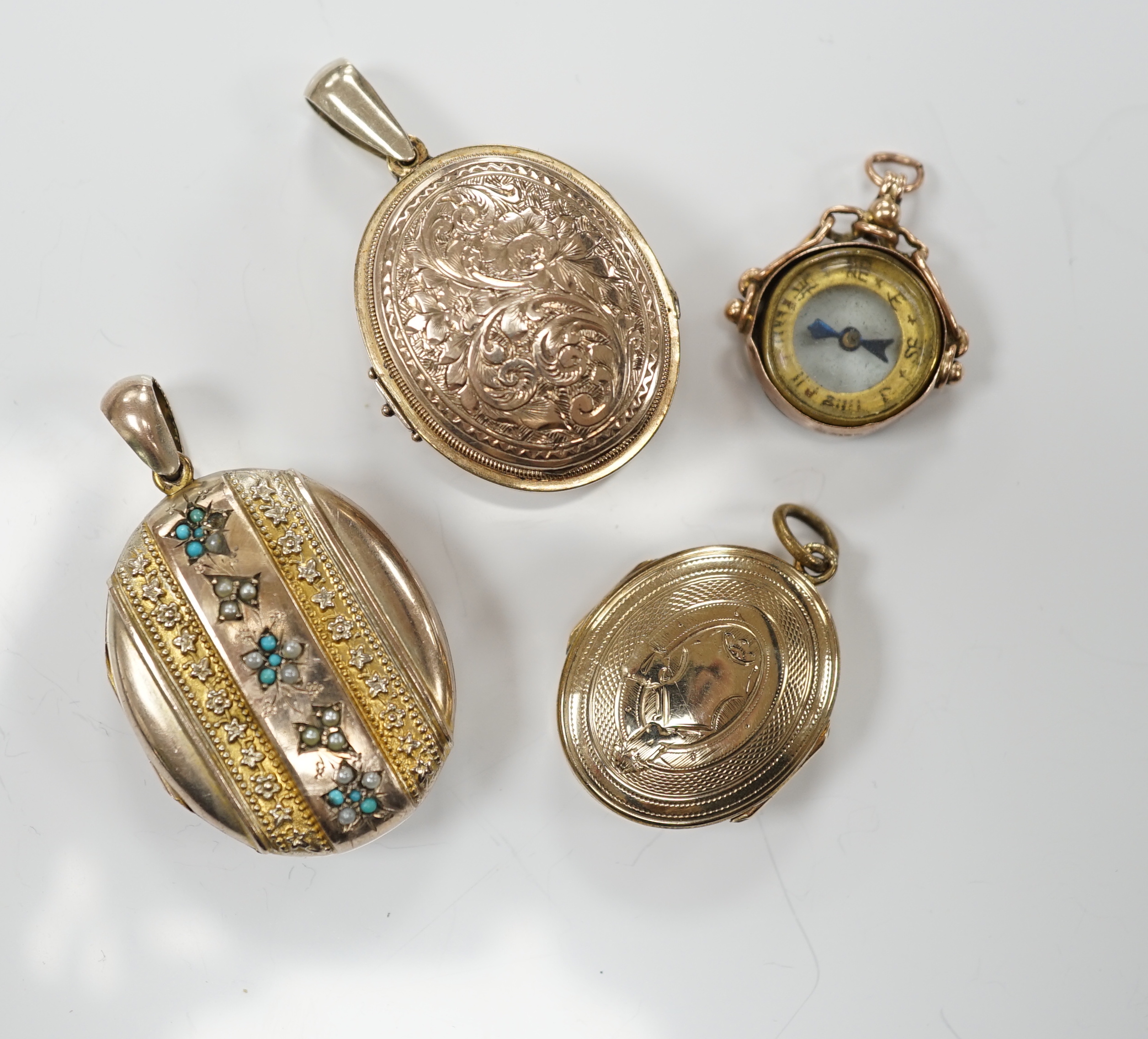 Three assorted early 20th century and later engraved yellow metal overlaid oval lockets including turquoise set, largest 33mm and a 9ct gold mounted compass charm.